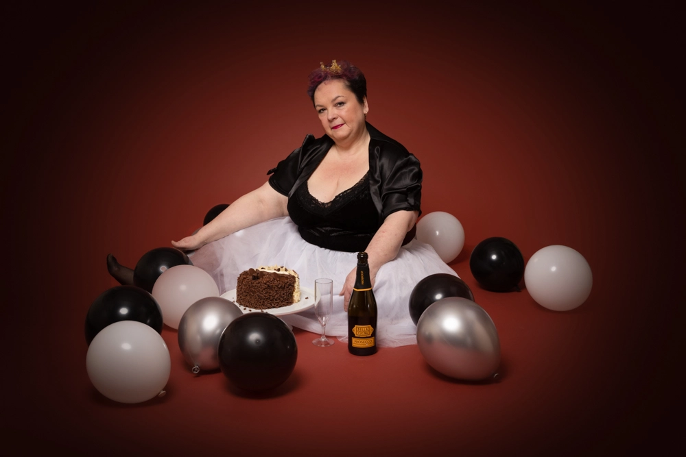 adult cake smash birthday photoshoot in Birmingham studio with balloons and celebration cake