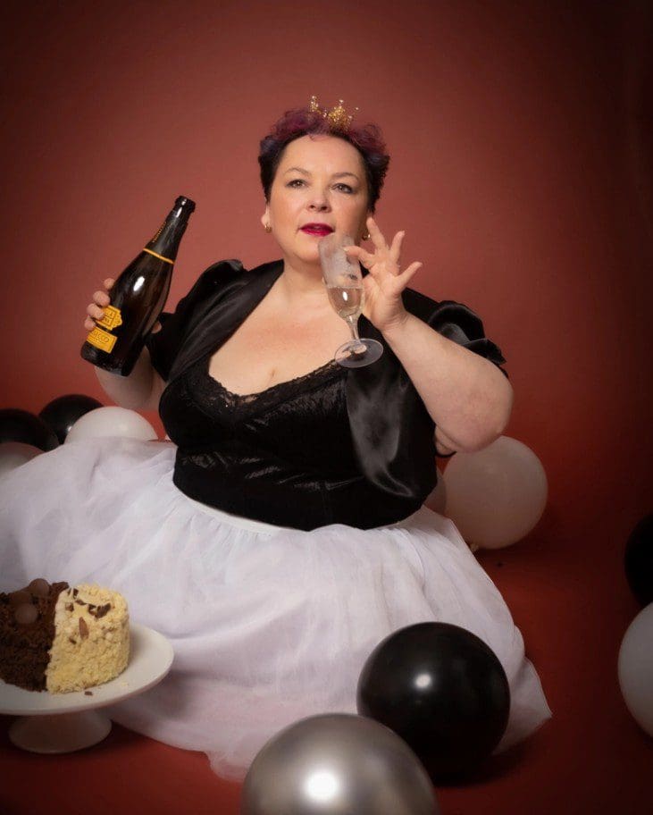 adult cake smash studio birthday portrait in Birmingham with balloons and celebratory drink