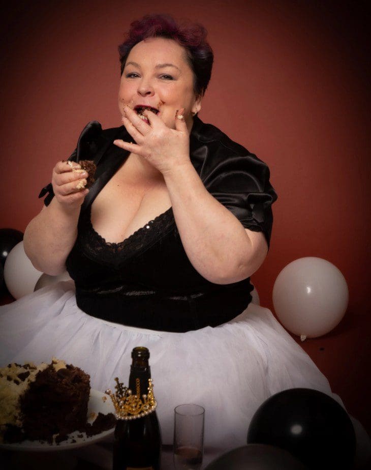 adult cake smash studio birthday photoshoot in Birmingham with playful cake moment