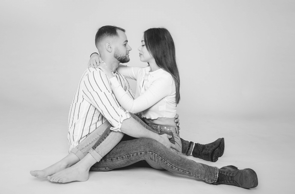 Couple smiling together in a relaxed pose during a professional Birmingham couple photoshoot by a skilled photographer.