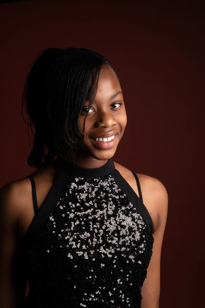 Teenage girl smiling in a studio portrait during a birthday photoshoot for children and teens in Birmingham.