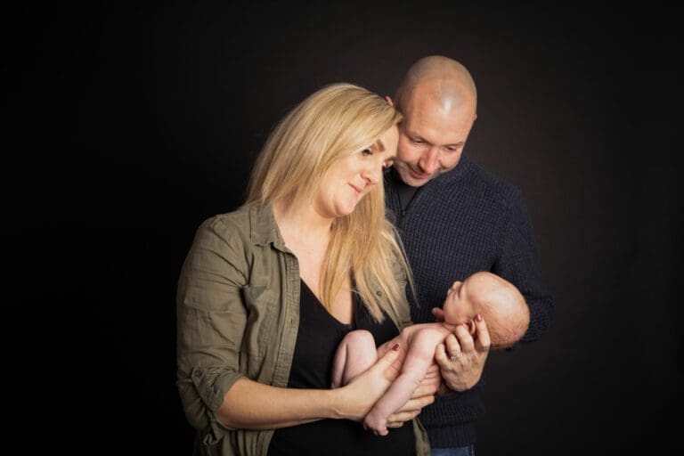 newborn baby with parents in Birmingham photography studio family portrait