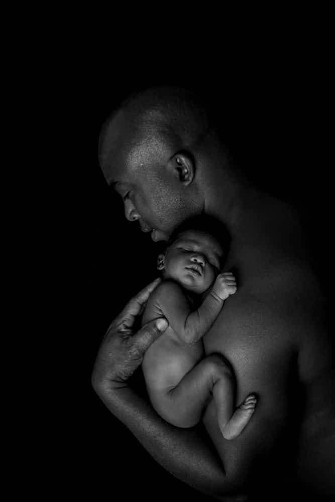 sleeping newborn baby skin to skin with parent during Birmingham photography studio session