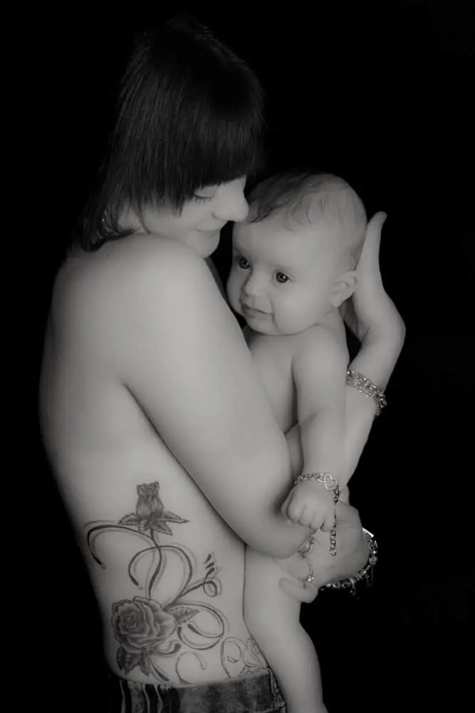 black and white newborn baby skin to skin with mother in Birmingham photography studio