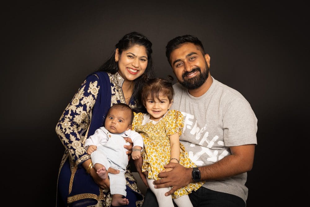 family of four smiling together during Birmingham family photography session