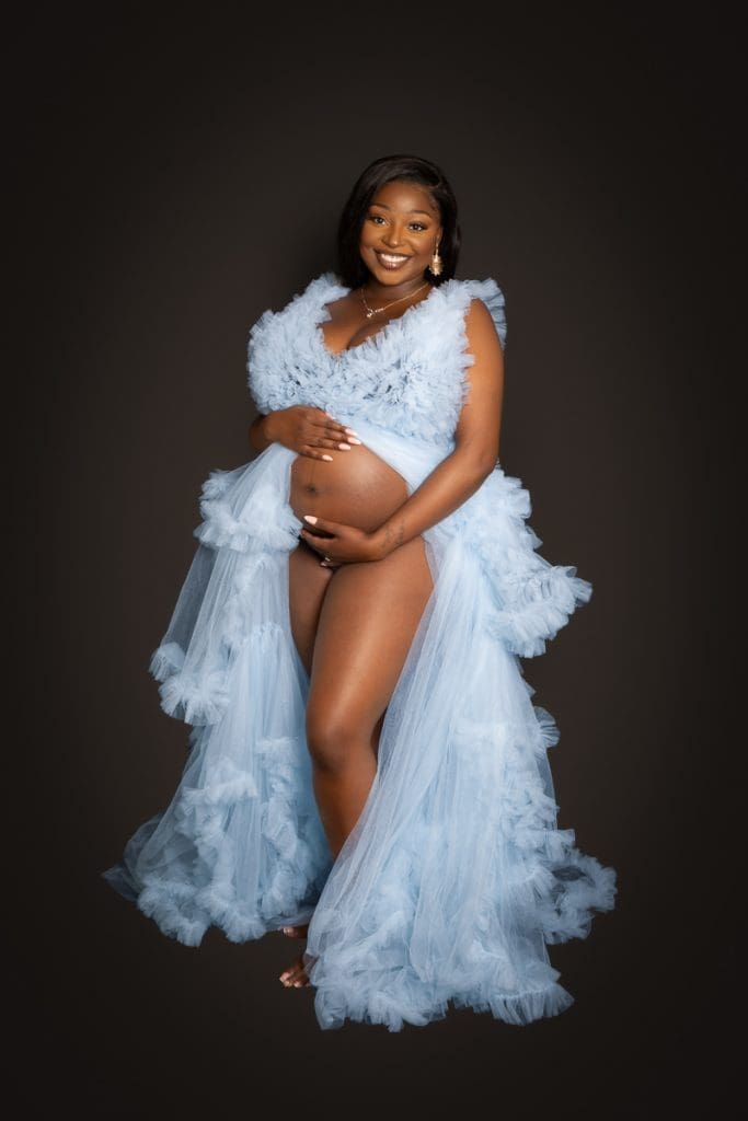 Studio maternity image highlighting natural curves and soft expression